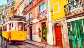 Yellow vintage tram on the street in Lisbon, Portugal. Famous travel destination
